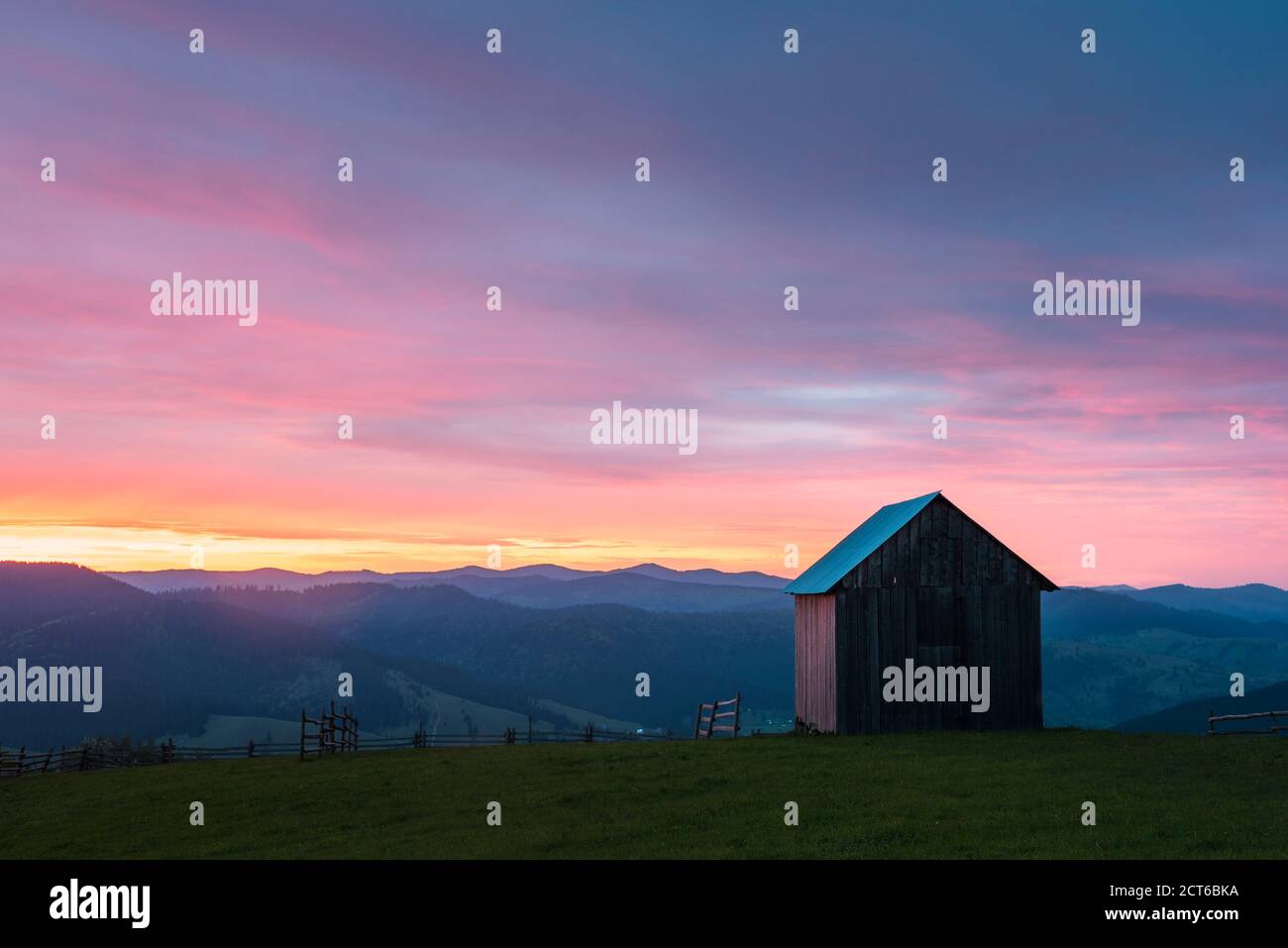 Rural Romanian landscape at sunrise in the Bukovina Region (Bucovina), Paltinu, Romania, background with copy space Stock Photo