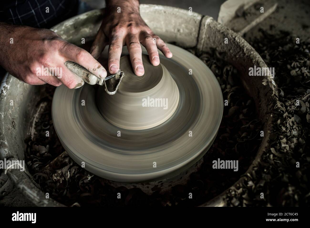 Throwing a pot on a pottery wheel at a Marginea Black Pottery and