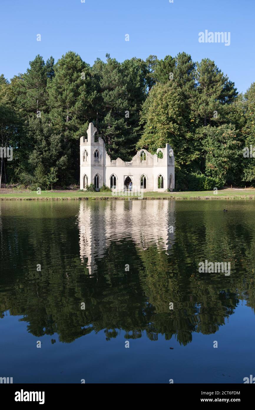 View of the Ruined Abbey from across the lake at Painshill Park in Surrey, UK. Stock Photo