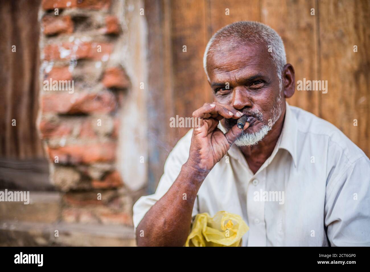 Portrait of a man smoking a cigar on the streets of Negombo on the West