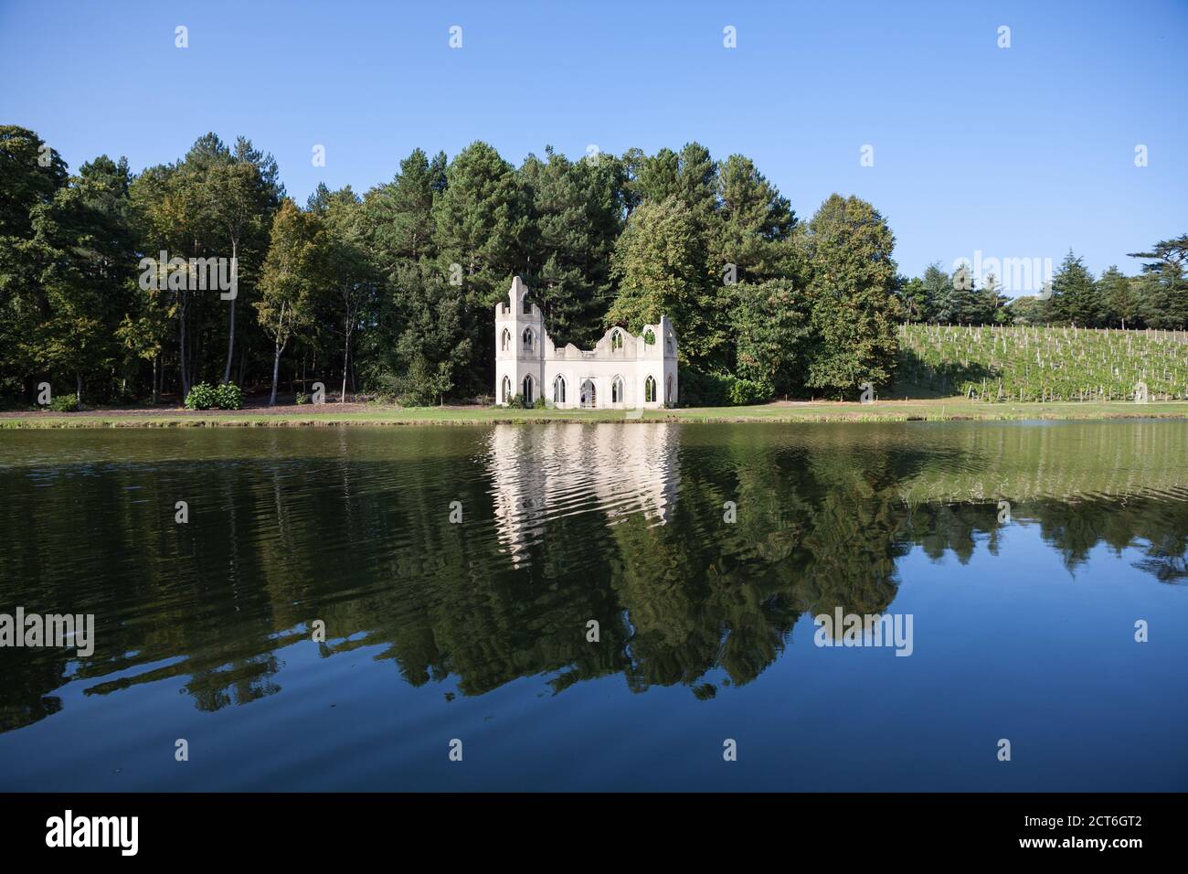 View of the Ruined Abbey from across the lake at Painshill Park in Surrey, UK. Stock Photo