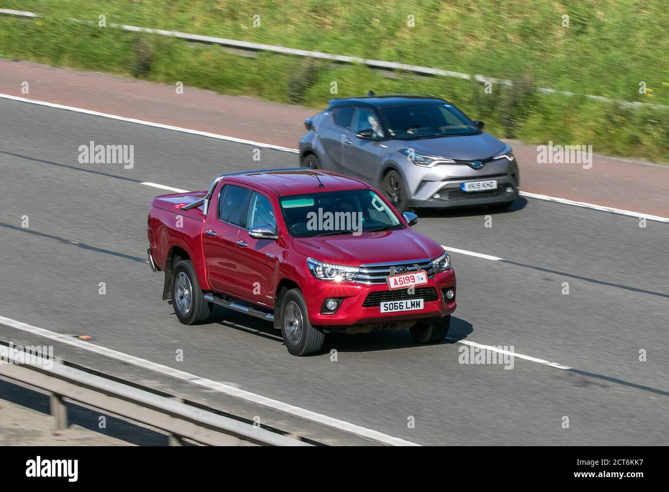 2017 red Toyota Hilux Invincible D-4d 4WD driving on the M6 motorway near Preston in Lancashire, UK. Stock Photo