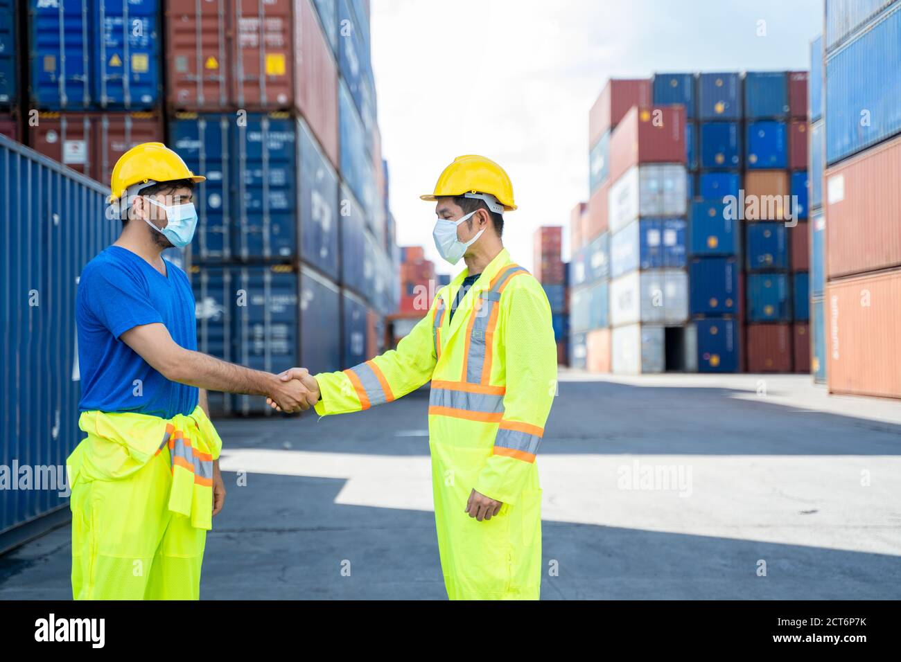 Workers wearing protective mask to Protect Against Covid-19 discussion ...