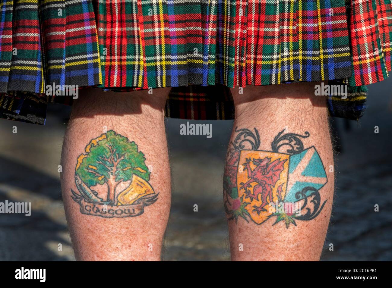 Man wearing a tartan kilt with tattoos on his legs showing Glasgow and support for Scottish independence, Taken at an independence rally, Glasgow, Stock Photo