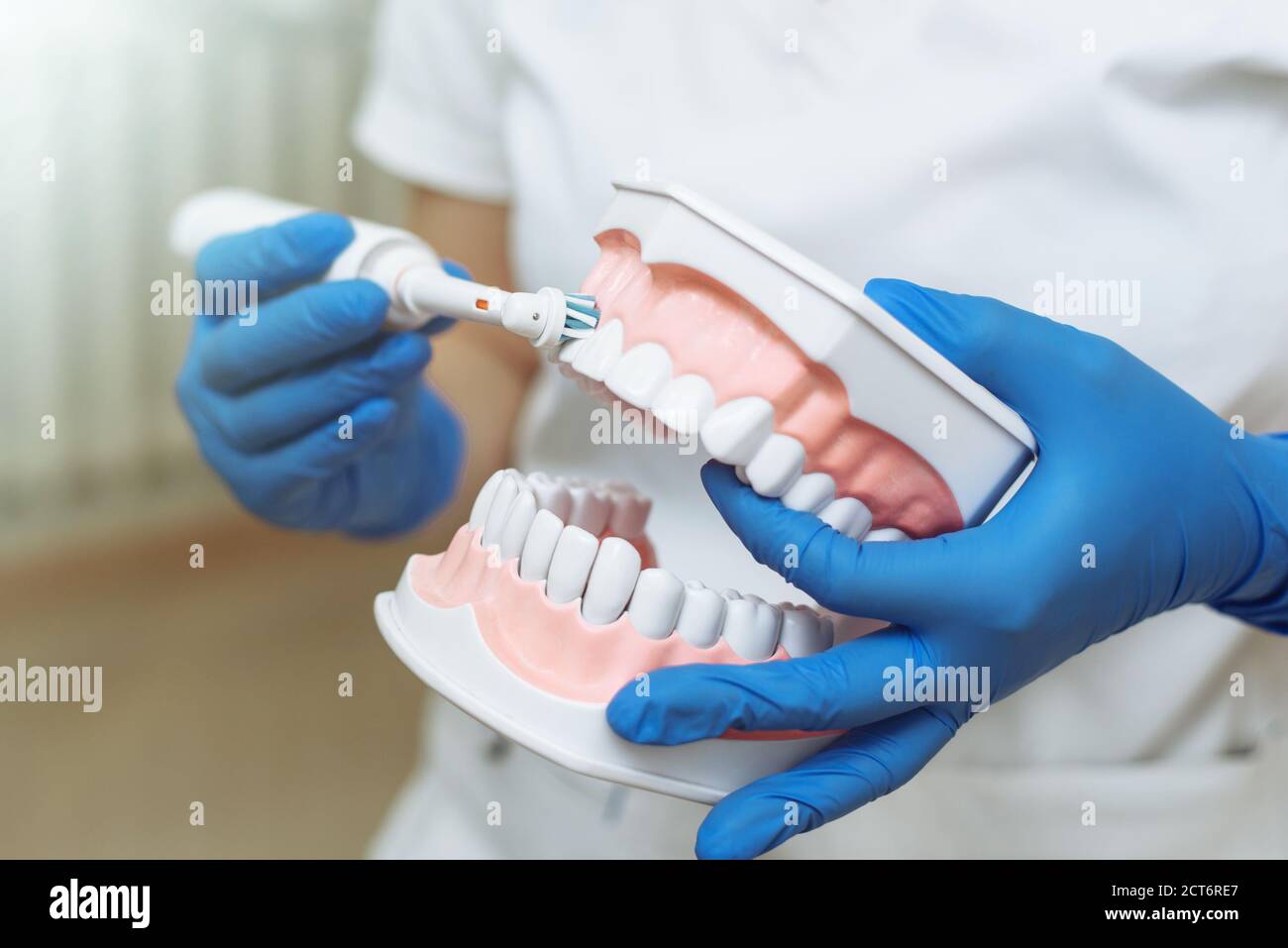Dentist showing patient how to brush teeth in dental clinic Stock Photo Alamy