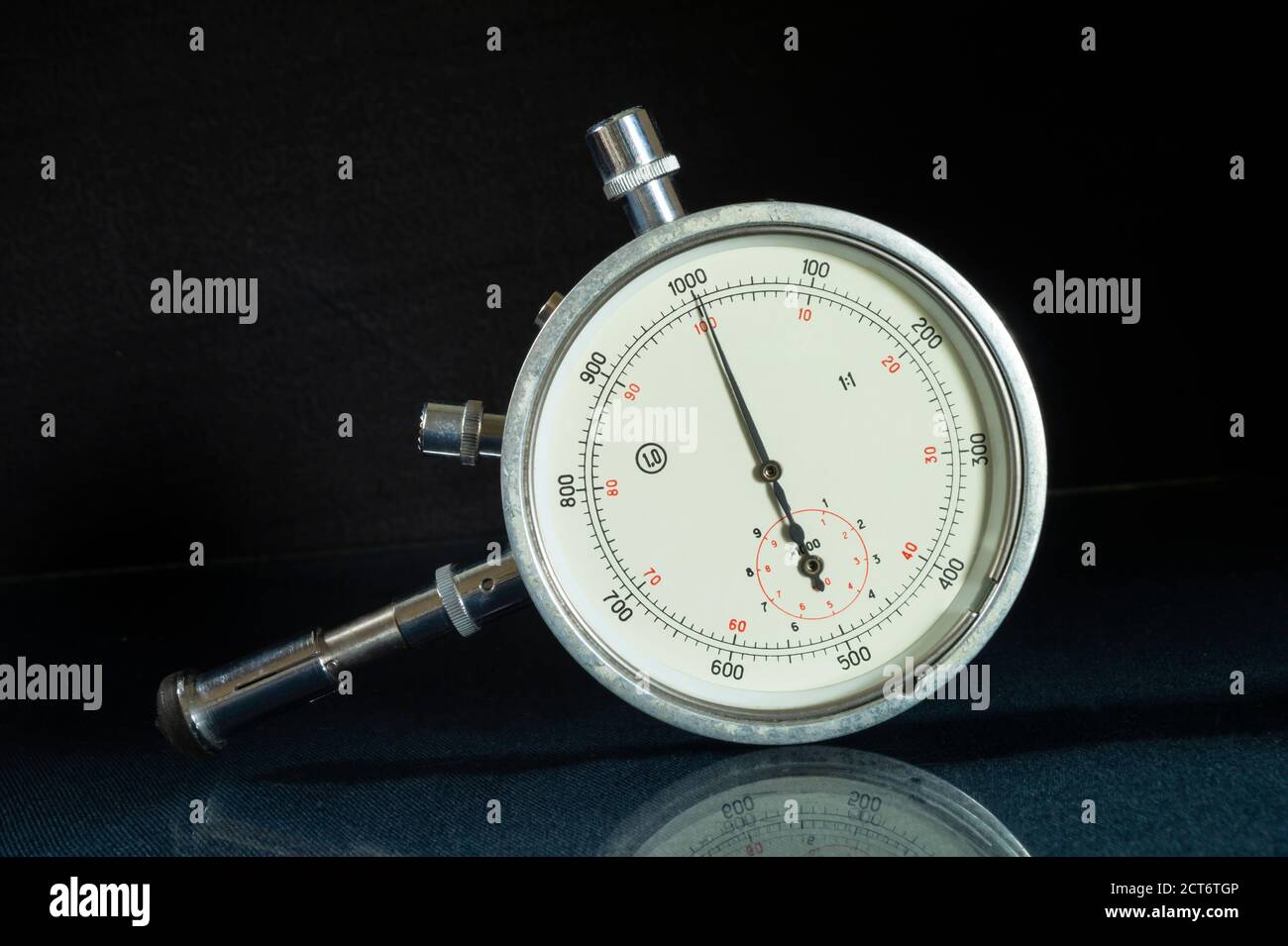 The Mechanical tachometer with arrow on black background. Instrument for measurement turn gross on engine Stock Photo