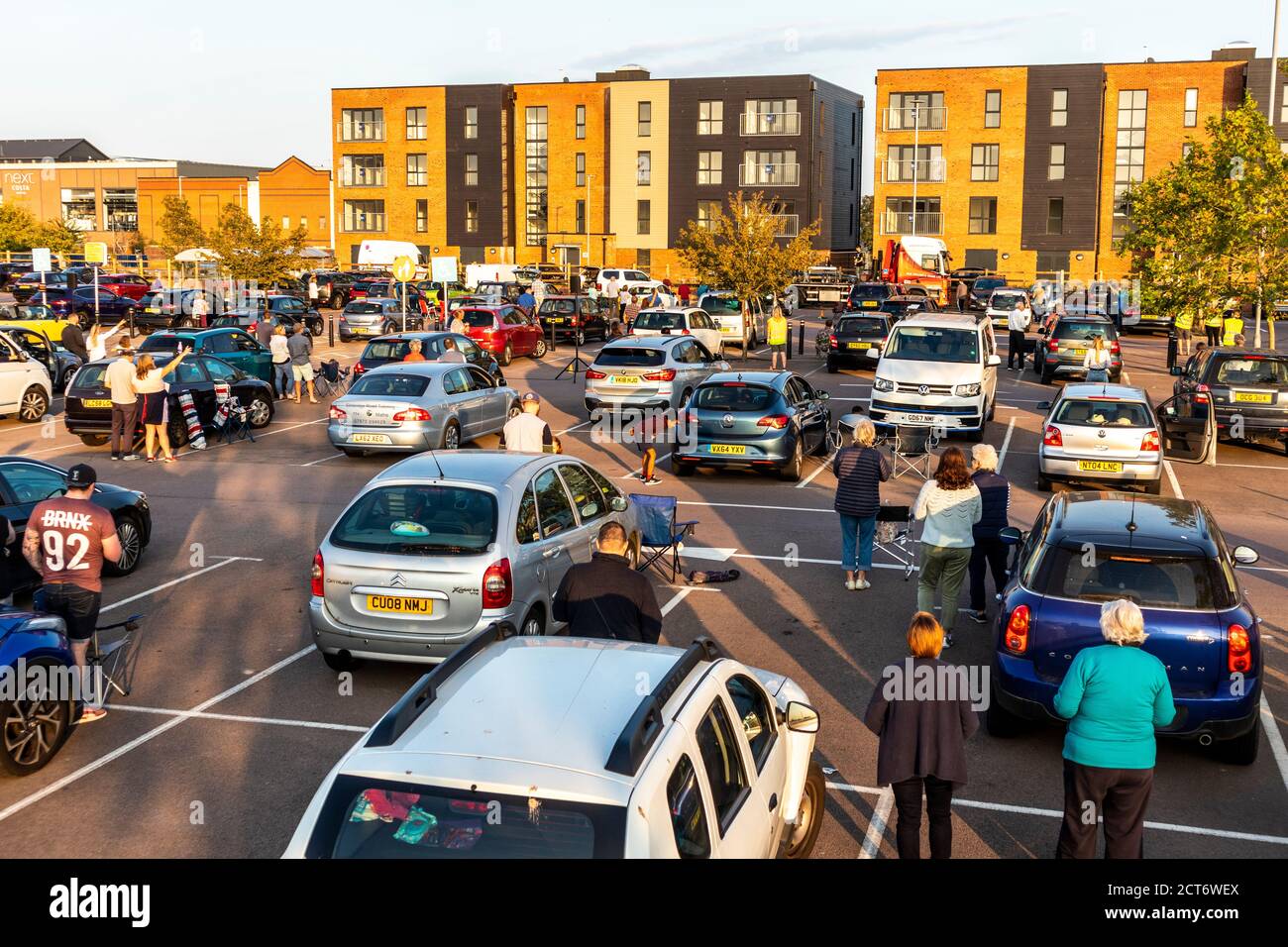 A drive in church service complying with Covid 19 restrictions on a Sunday evening in the car park of Sainsburys at Gloucester Quays, Gloucester UK Stock Photo