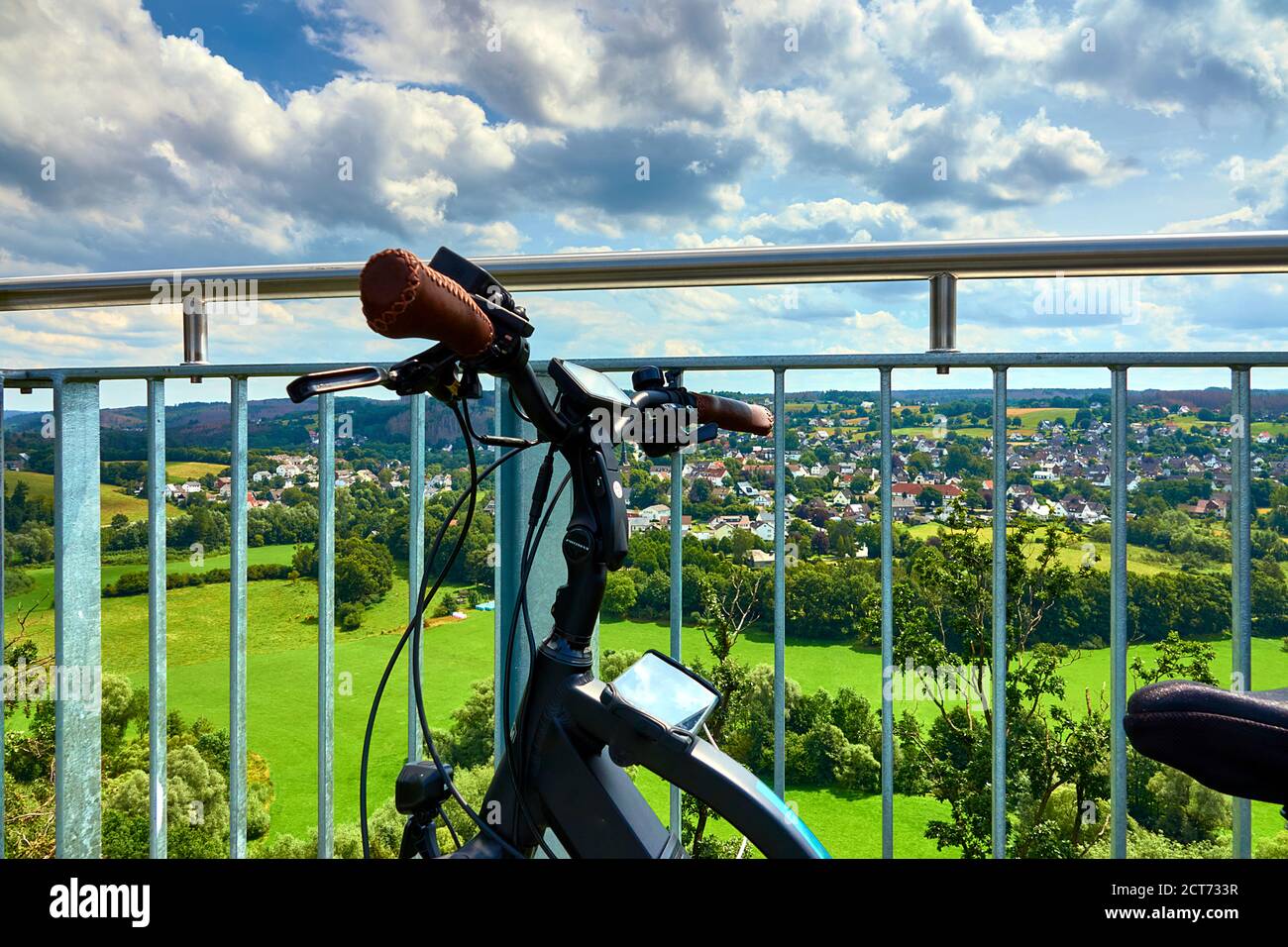 Bicycle hitched to the railing of a viewing platform of a skywalk in