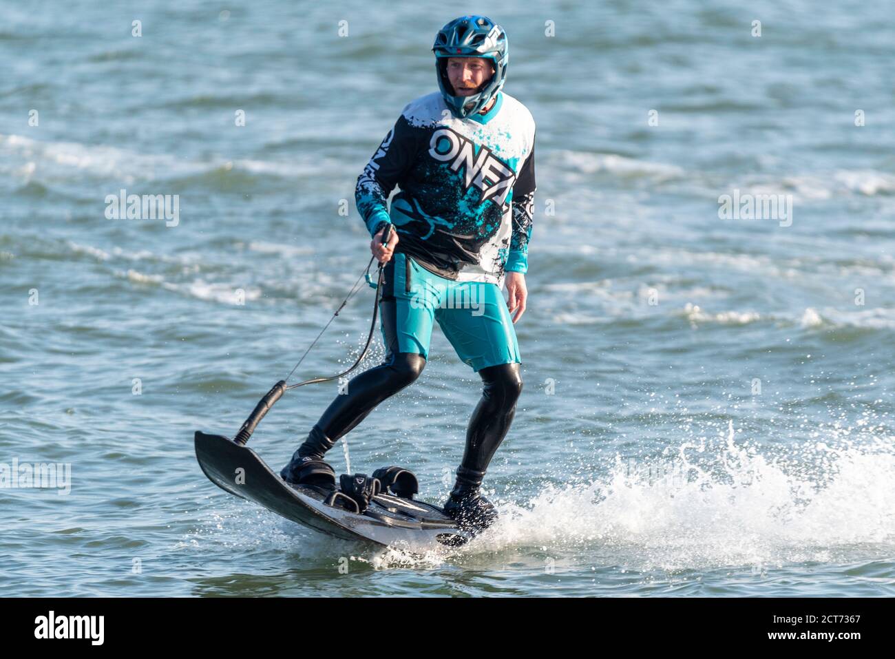 Southend on Sea, Essex, UK. 21st Sep, 2020. The weather dawned foggy and cloudy in Southend on Sea but broke into a warm and sunny afternoon. People are out enjoying the afternoon high tide with some taking to the water. A male is riding a petrol powered jet board. Motorised surfboard Stock Photo