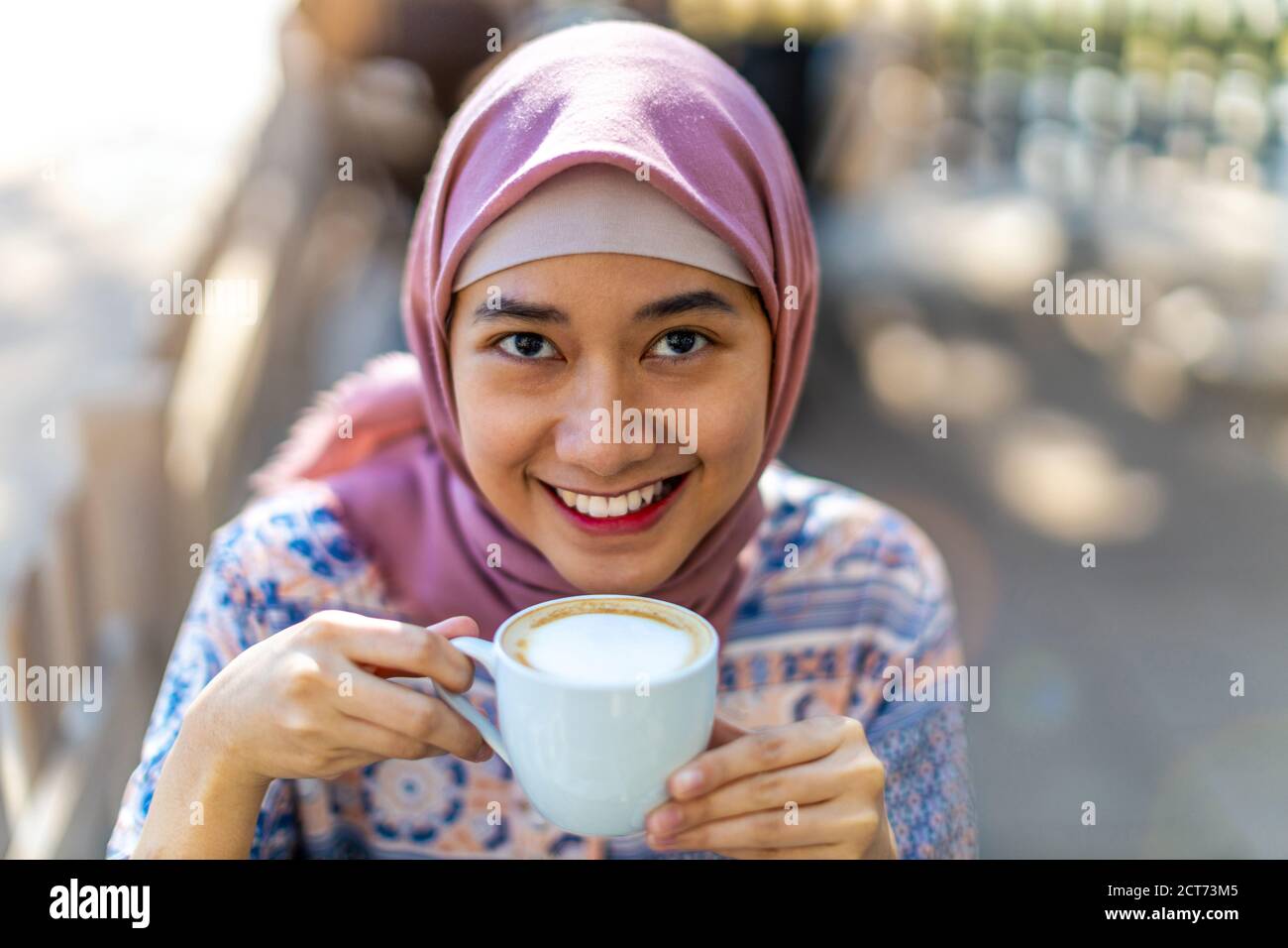 Happy Young Muslim Woman Drinking Coffee Stock Photo