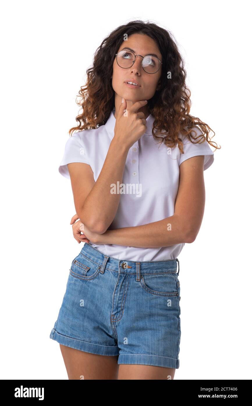 Portrait of young woman in glasses with curly hair thinking looking up ...