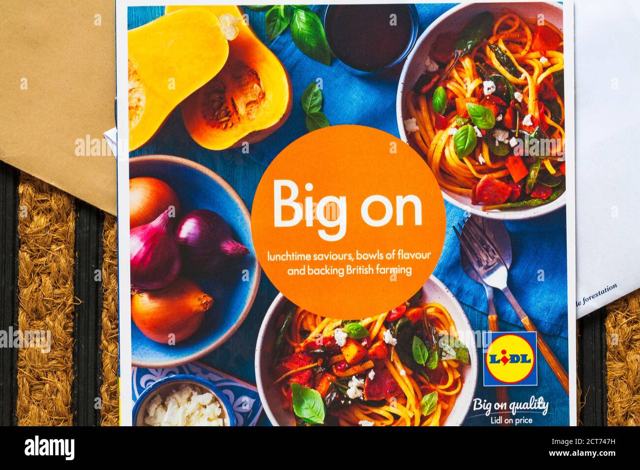 unsolicited mail junk mail on doormat - big on quality Lidl on price - big on lunchtime saviours, bowls of flavour and backing British farming booklet Stock Photo