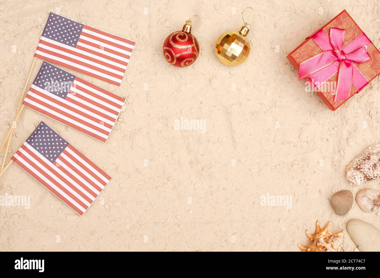 New Year and Christmas holidays in America. America flag on the beach with a gift with copy space Stock Photo