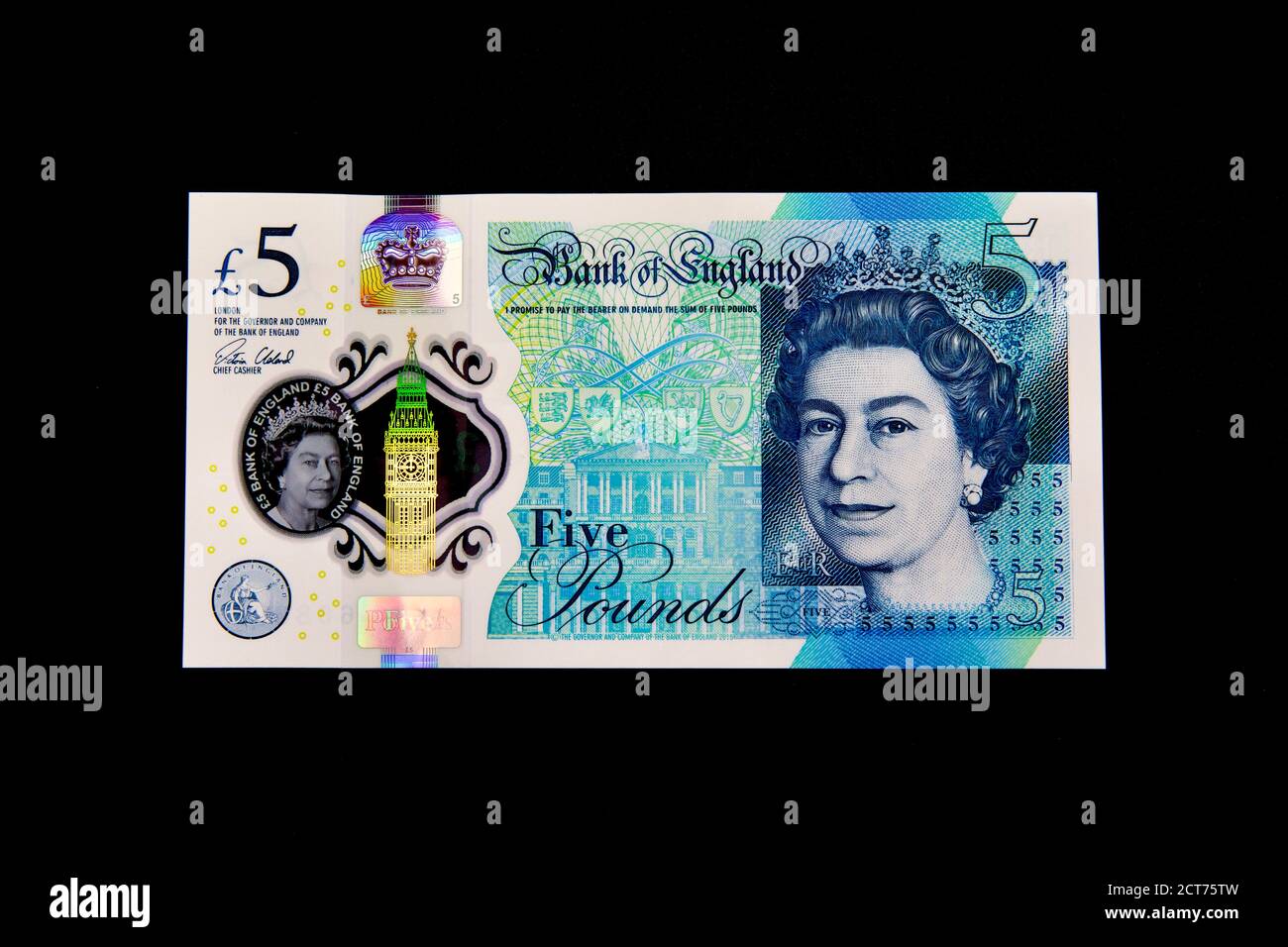 The new £5 polymer banknote featuring Sir Winston Churchill on a black background Stock Photo