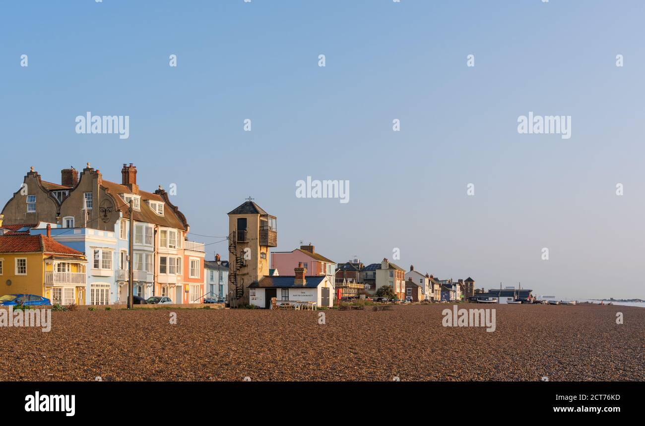 View of Aldeburgh Beach with early morning sunlight and blue sky. Stock Photo