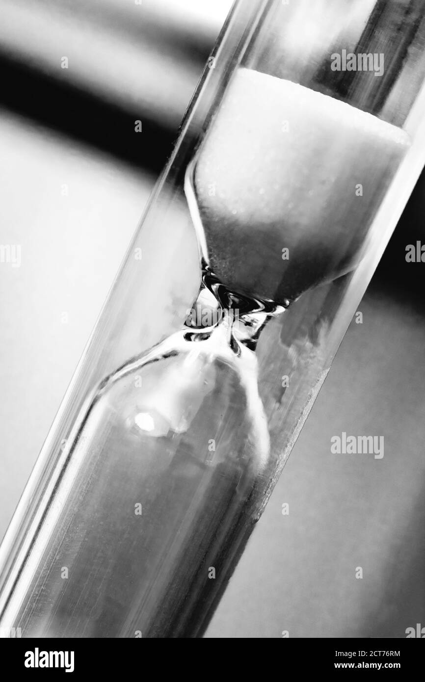 Hourglass with shadow closeup in black and white Stock Photo