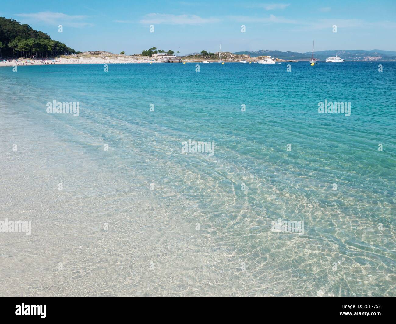 Crystal clear blue sea at the Cies islands. Turquoise shallow water and white Rodas sandy beach. Stock Photo