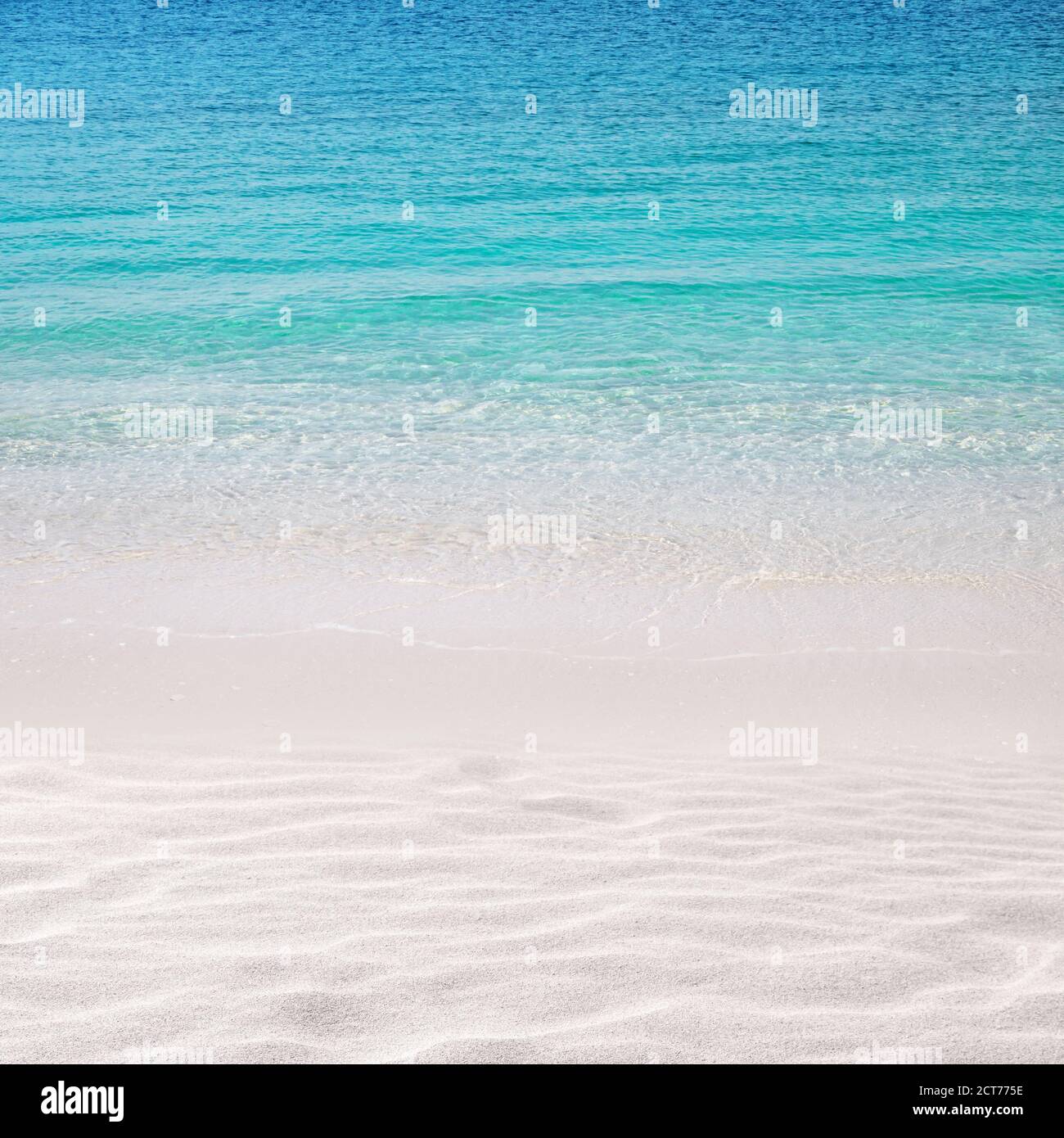 White sandy beach background. Crystal clear turquoise sea. Summer paradise. Wind waves. Stock Photo