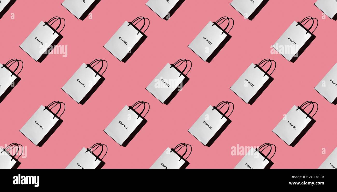 Seamless pattern of white shopping bags with the CHANEL logo on a pink background. Concept of shopping, gifts, buyer, discounts. Top view, background, Stock Photo