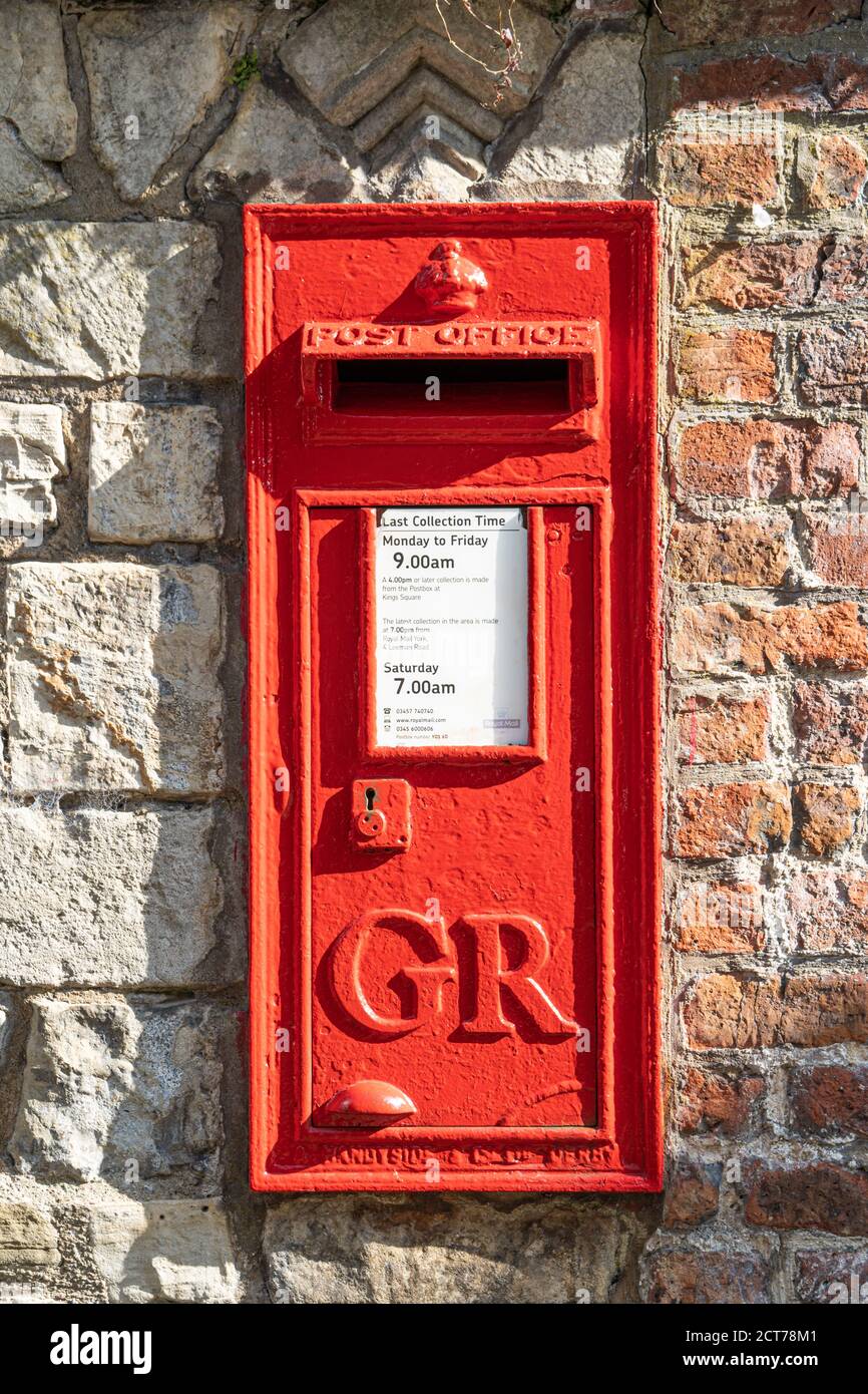 A UK red cast iron wall box post box from the reign of King George VI (GR), York, UK Stock Photo