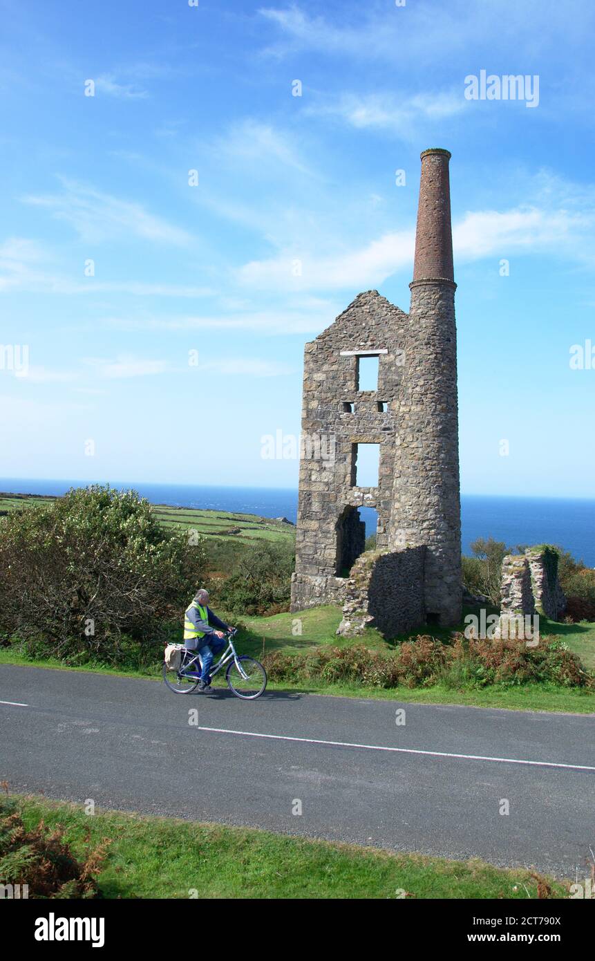 Man cycling past Carn Galver Mine in Cornwall on the road between St Ives and St Just Stock Photo