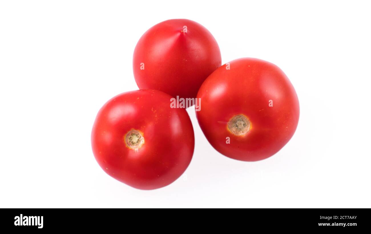 Three whole red tomatoes on a white background in isolation Stock Photo