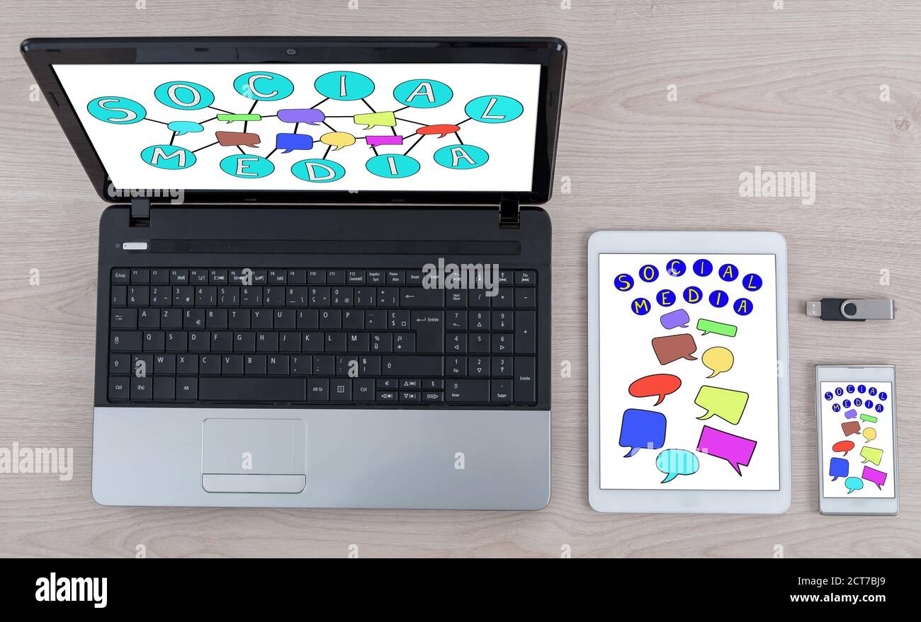 Social media concept shown on different information technology devices Stock Photo