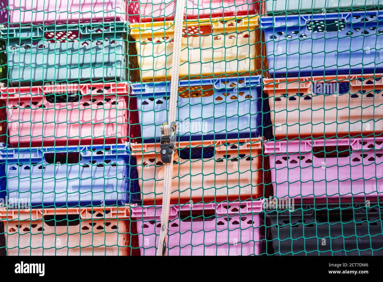 UK, London, Camden Town, 12 September 2020.Colored plastic boxes for transportation on a lorry fixed by Truck Net and Ratchet Strap Stock Photo