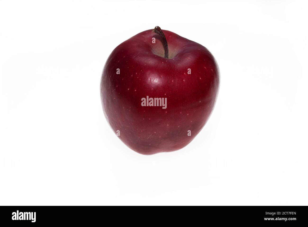 The yellow apple with red spots lies in a hand on a white background