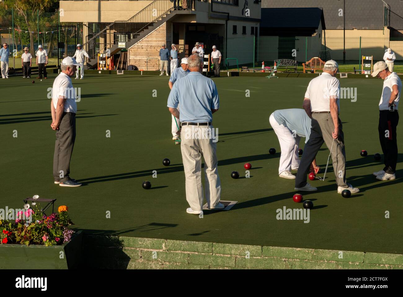 Several retirees playing lawn bowls at The Causeway Tennis and Bowls Club in Dungarvan Ireland as active pensioners and retirement concept. Stock Photo