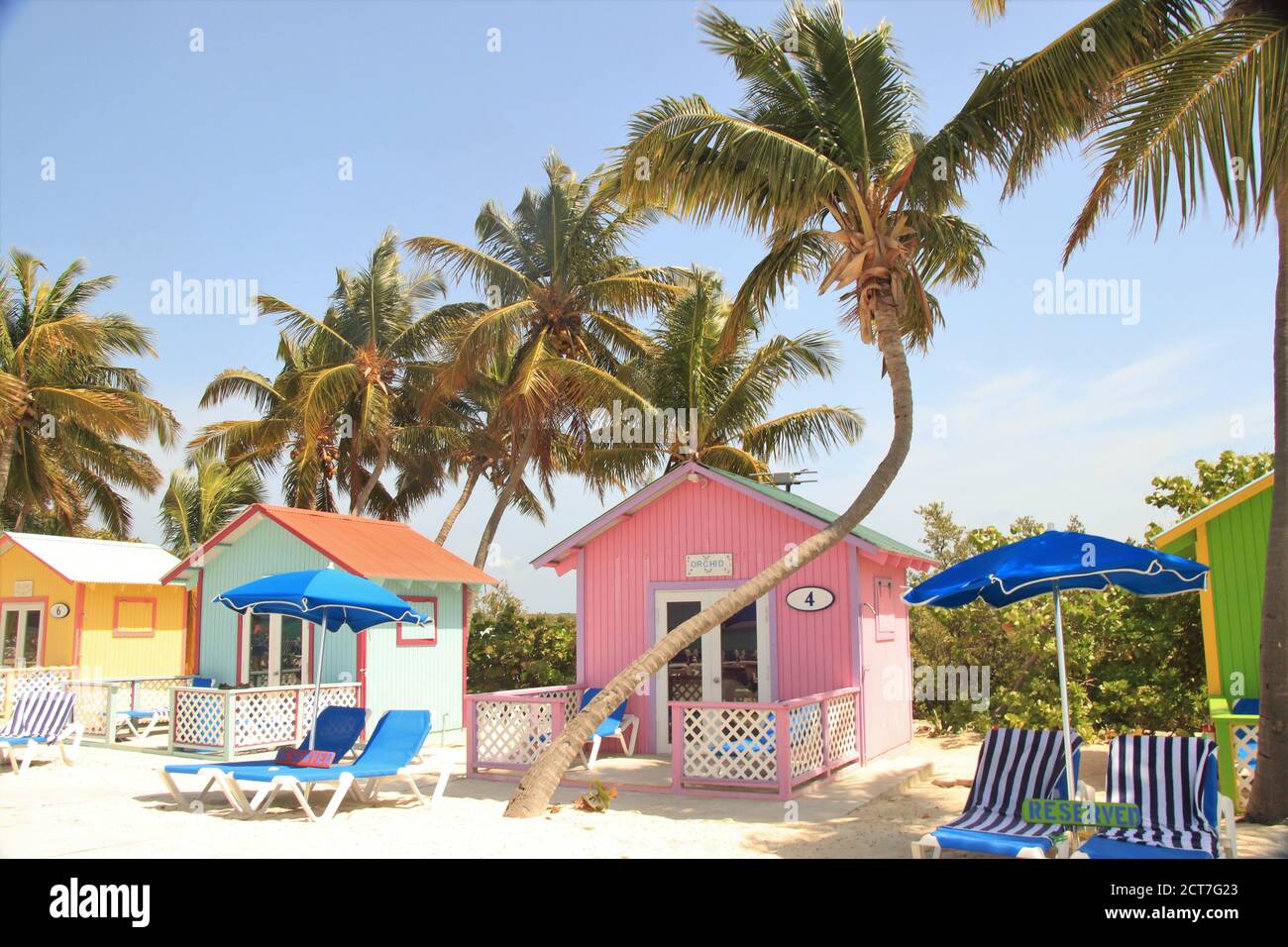 Colorful cabanas and lounge chairs along the beach at Princess Cays in the Bahamas Stock Photo