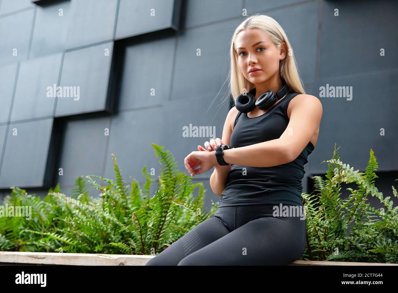 Female Runner Checks Workout Performance On Smart Watch Stock Photo