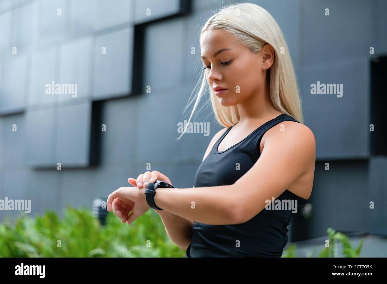 Woman checking her fitness smart watch device Stock Photo