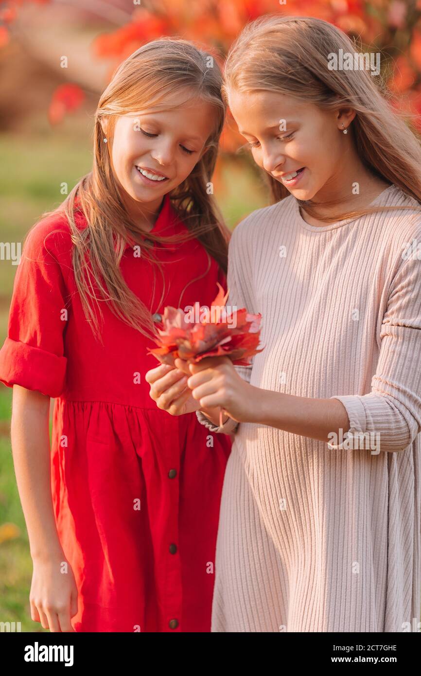 Little adorable girls outdoors at warm sunny autumn day Stock Photo - Alamy