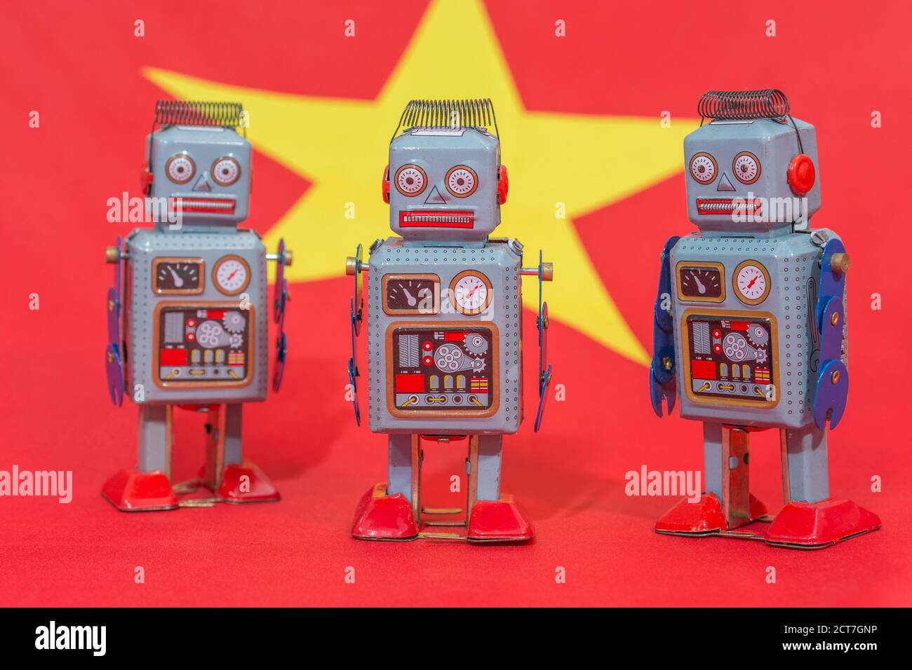 Wind-up clockwork toy robot on Chinese flag b/gd. For Chinese bots influencing US elections, advances in Chinese AI, China troll farm, China AI Stock Photo