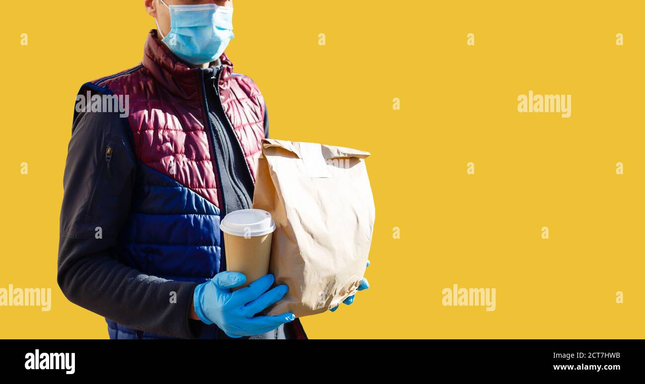 https://c8.alamy.com/comp/2CT7HWB/delivery-man-in-mask-and-gloves-bring-fresh-food-to-customers-home-stay-home-online-shopping-concept-yellow-background-2CT7HWB.jpg