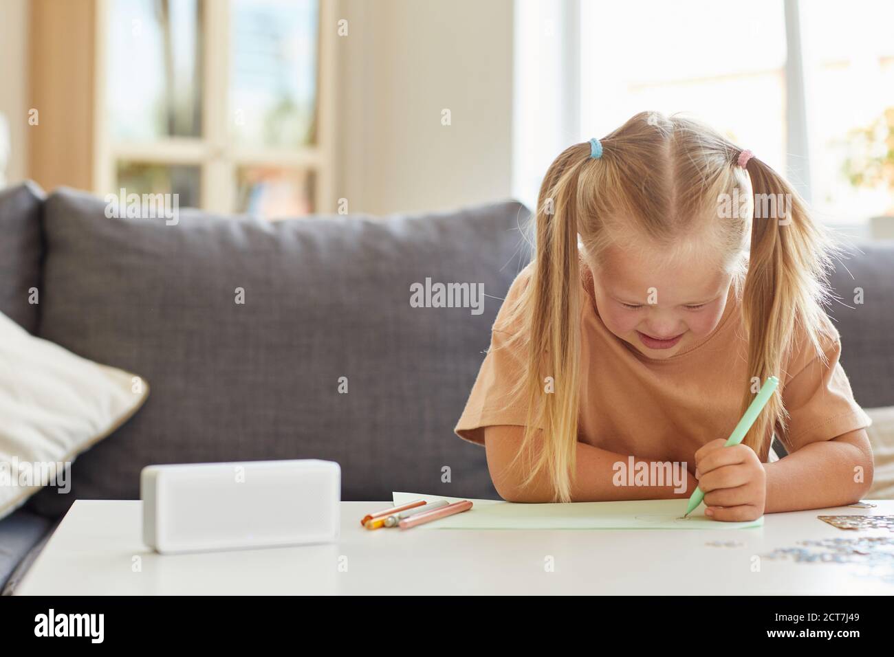 Front View At Cute Little Girl With Down Syndrome Drawing Pictures During Development Lessons At Home Copy Space Stock Photo Alamy