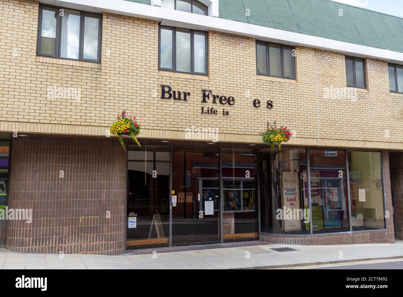The offices of the Bury Free Press newspaper ("Life is Local") with many missing letters, King's Road, Bury St Edmunds, Suffolk, UK. Stock Photo