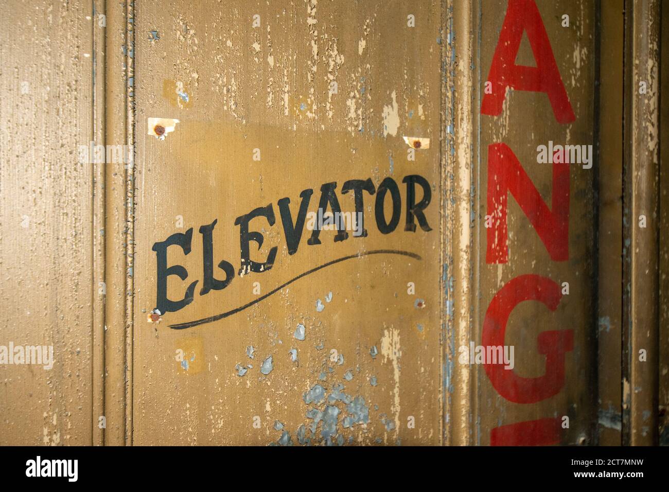 An Old Fashioned Door With Text That Says Elevator on It Stock Photo