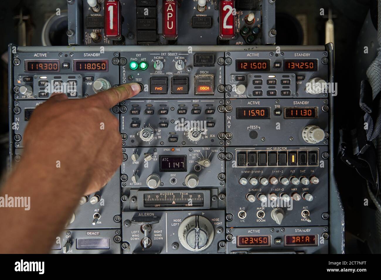 Pushing the button on control panel while piloting the plane Stock Photo