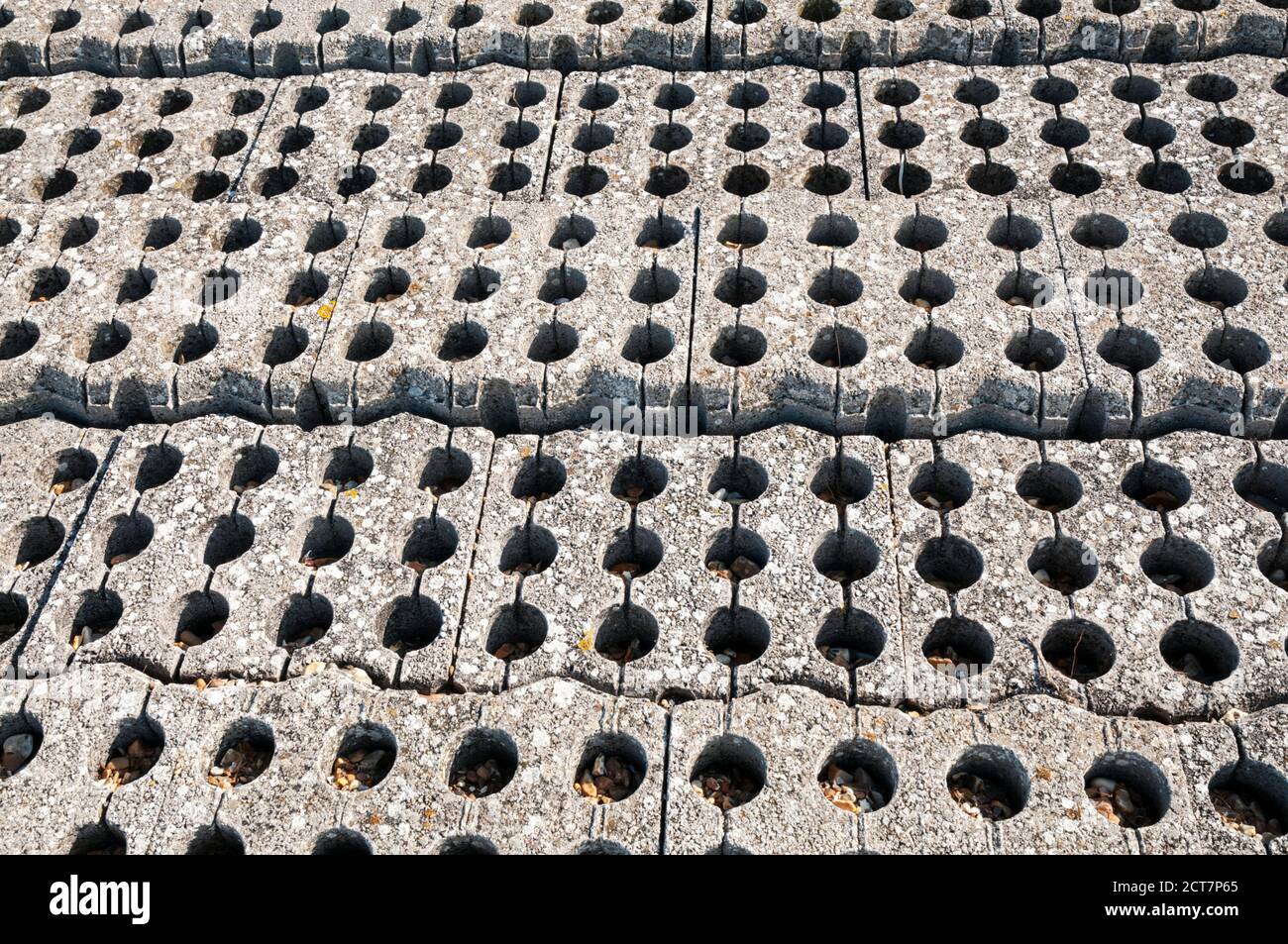 Pattern formed by interlocking concrete blocks used as part of coastal flood protection works. Stock Photo