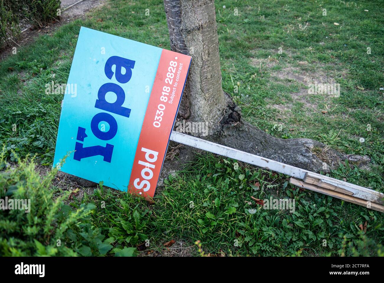 Yopa estate agency sold sign board dumped on ground, in Southend on Sea, Essex, UK. Online internet estate agent. Falling property market Stock Photo
