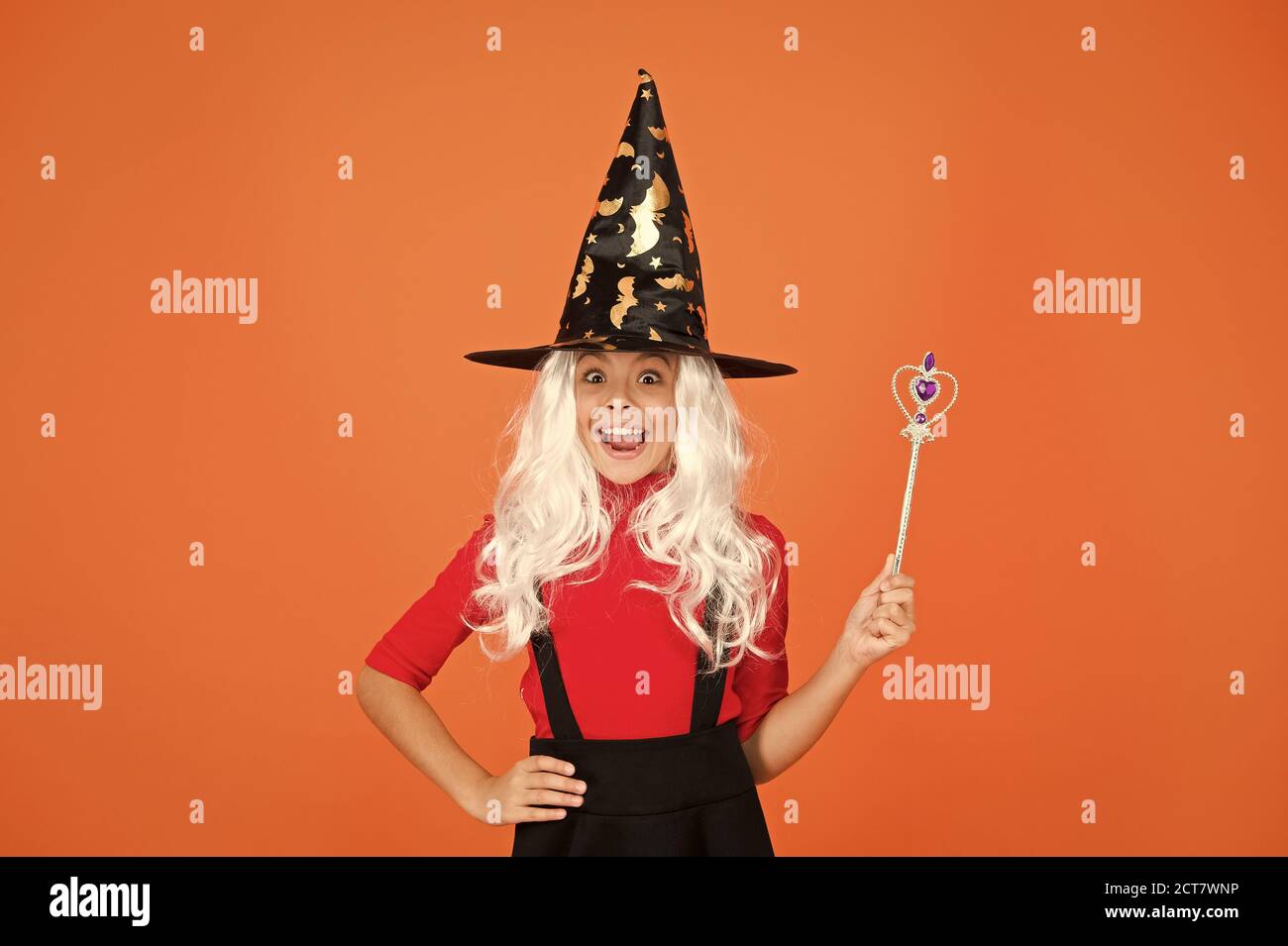 Add magic to your life. witch do magic. small child witch hat. trick or treat. supernatural charmer. kid enchantress wave magic wand. happy halloween. believe in magic. small girl halloween party. Stock Photo