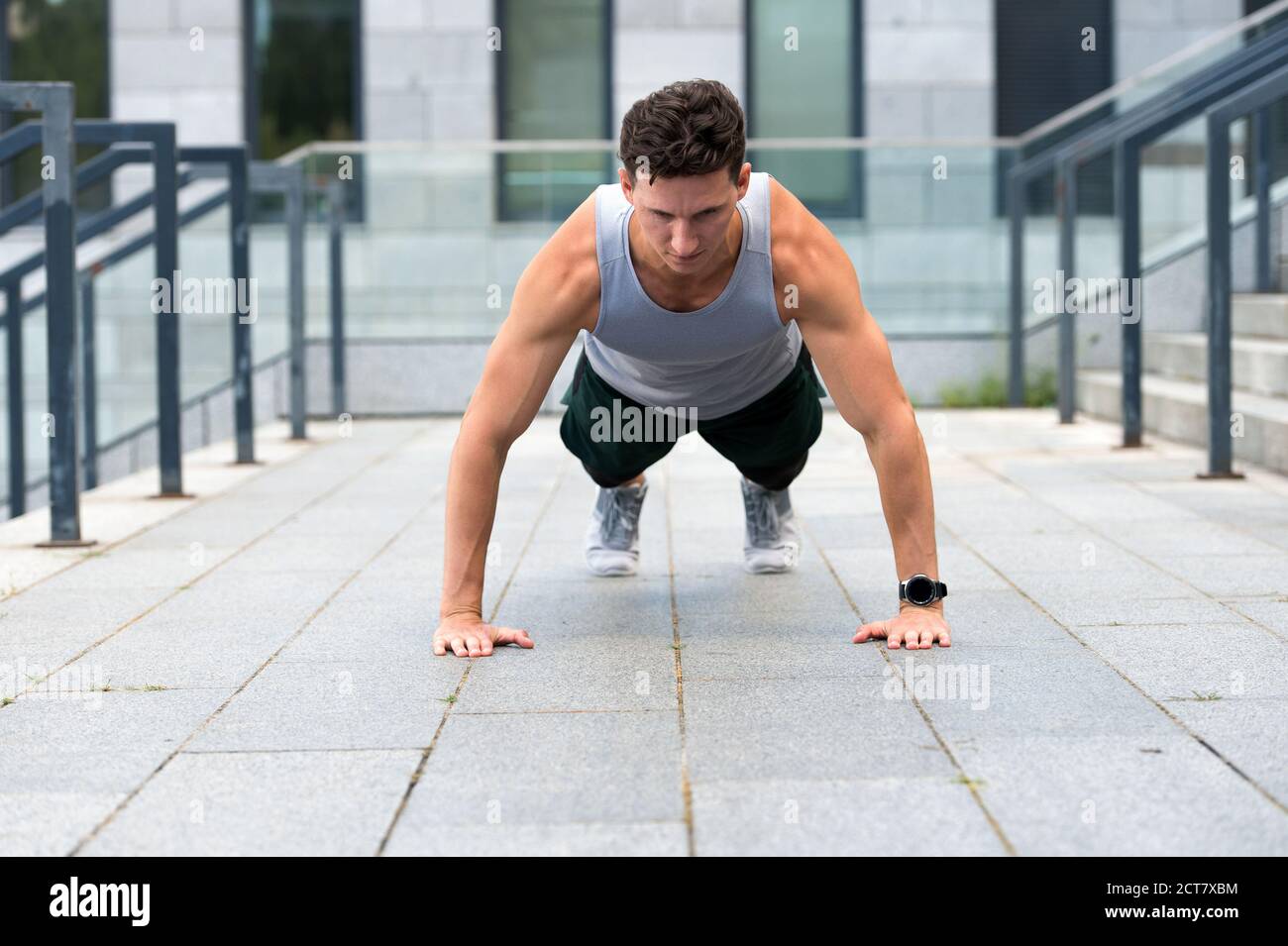 Athletic man doing push ups, urban workout concept Stock Photo - Alamy