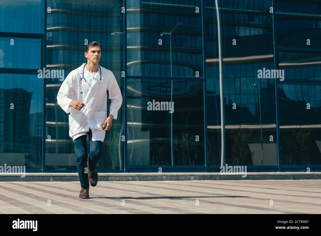 in full growth. a concerned doctor runs to help. Stock Photo