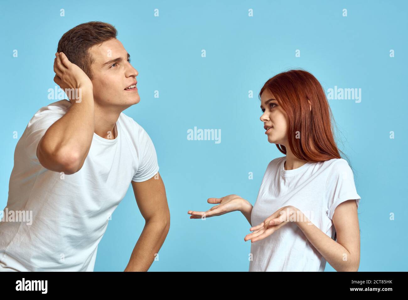 Young woman and man stinks relationship on blue background cropped view of couple in love Stock Photo