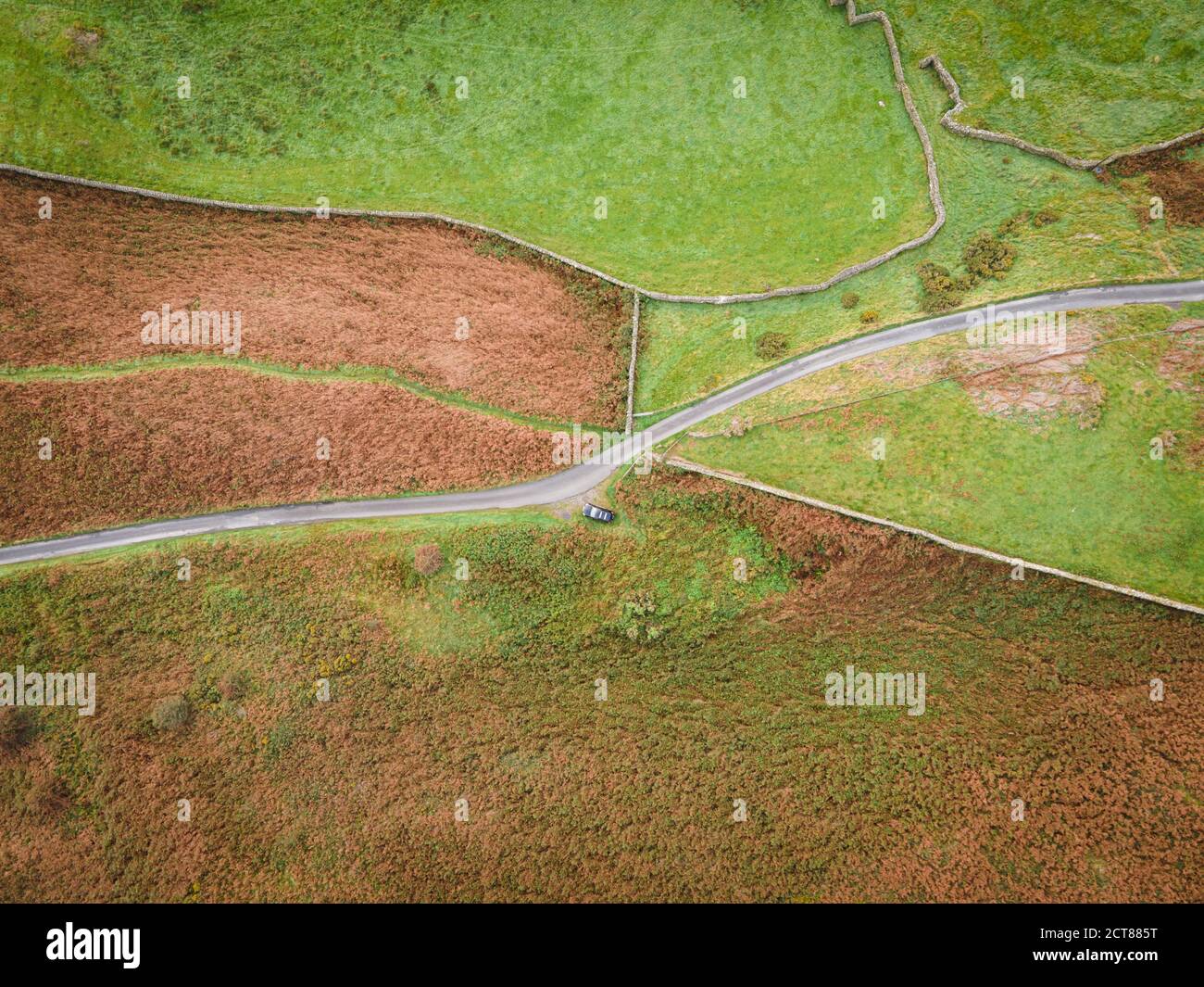 Looking down from 120m onto the fell road across Lowick Beacon, the bracken is almost entirely brown now as autumn starts to take hold. Stock Photo