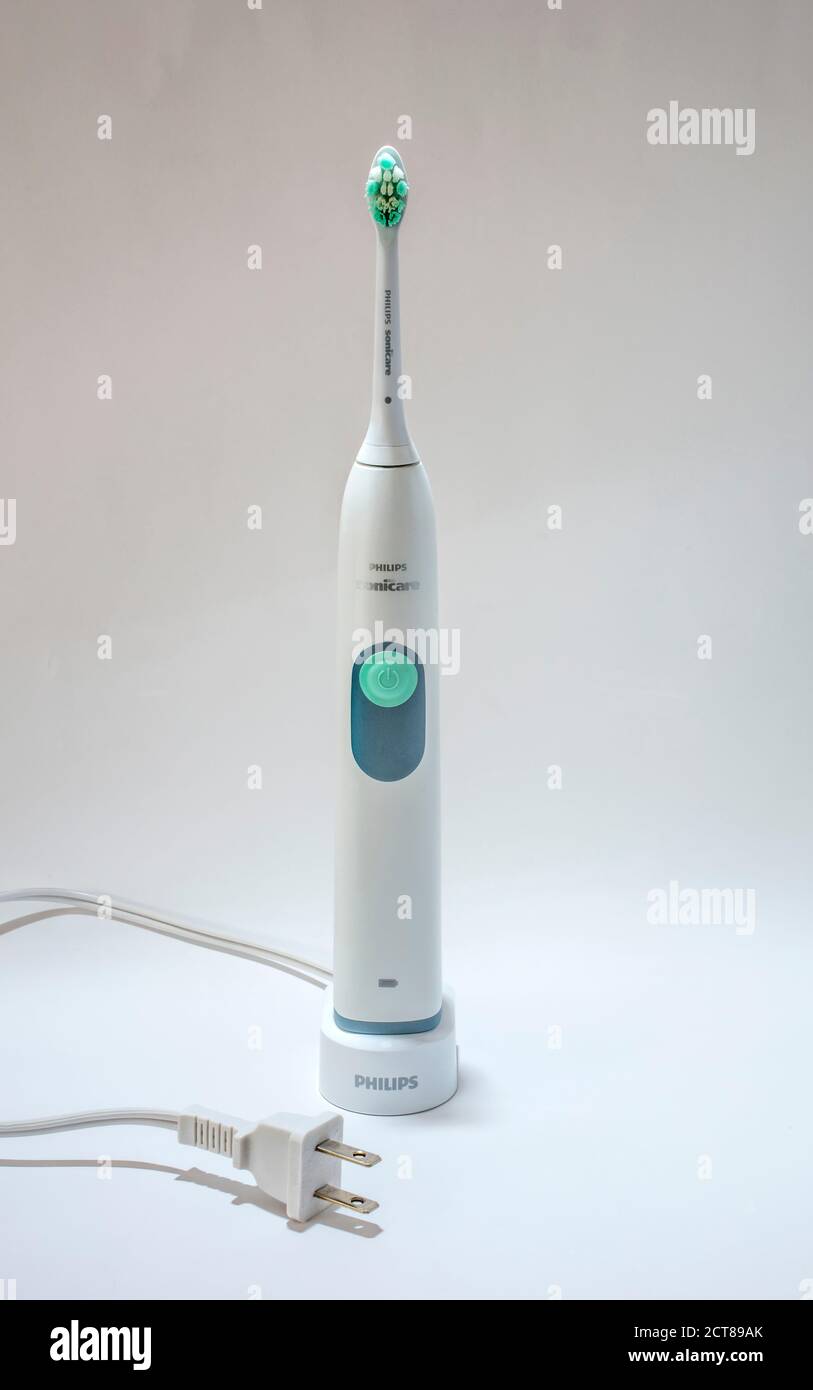 Electric toothbrush on charging stand with North American plug Stock Photo