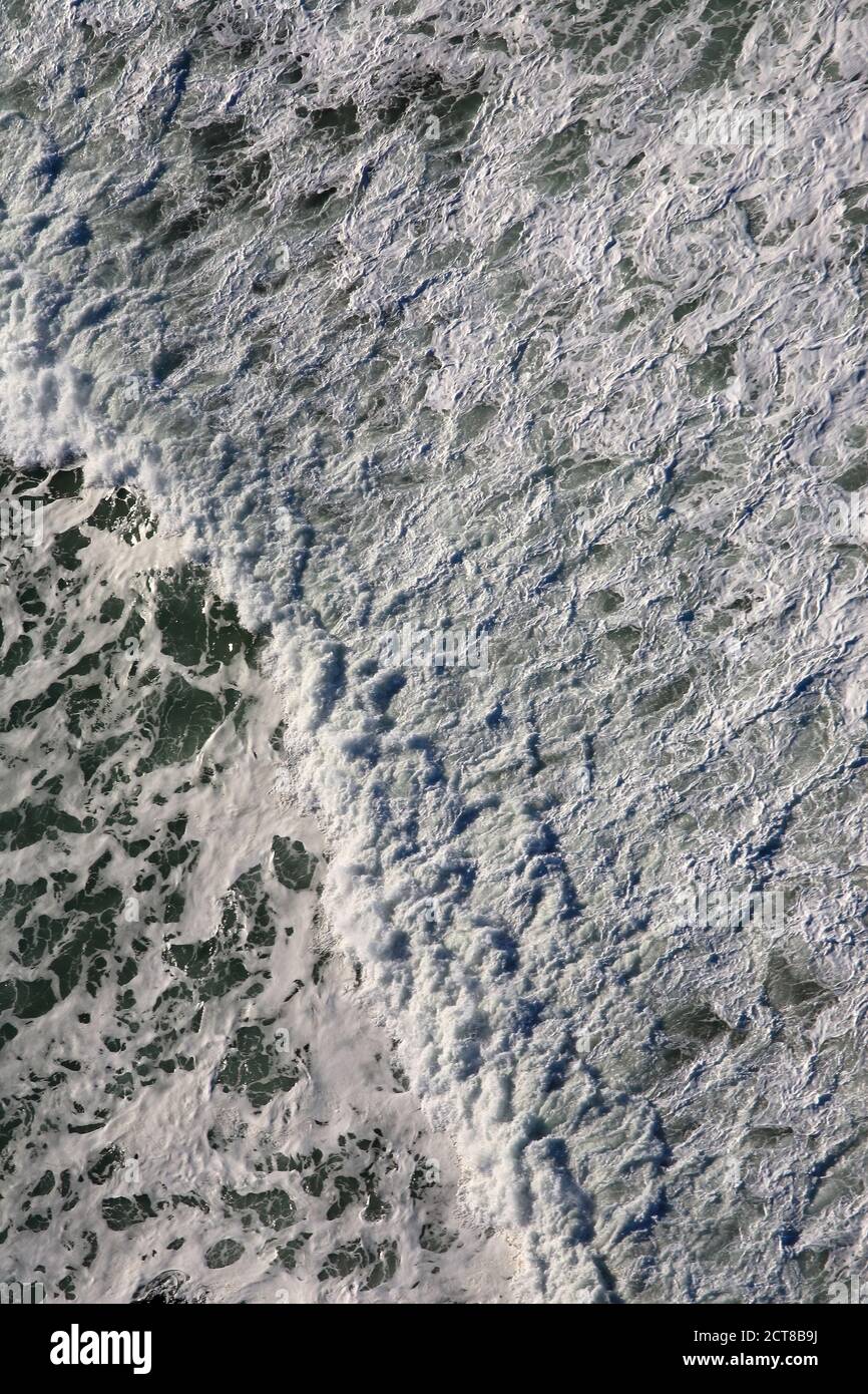 Aerial view of surf breaking on beachwhite Stock Photo