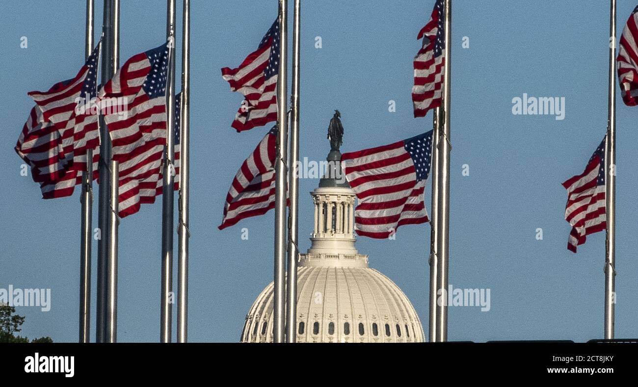 Washington, United States. 21st Sep, 2020. The U.S. Capitol is seen between the flags that are at half mast at the Washington Monument in honor of Supreme Court Justice Ruth Bader Ginsburg on Monday, September 21, 2020 in Washington, DC. Ginsburg died on Saturday, September 19th and will lie in state at the U.S. Capitol on Friday, September 25, 2020. Photo by Pat Benic/UPI Credit: UPI/Alamy Live News Stock Photo